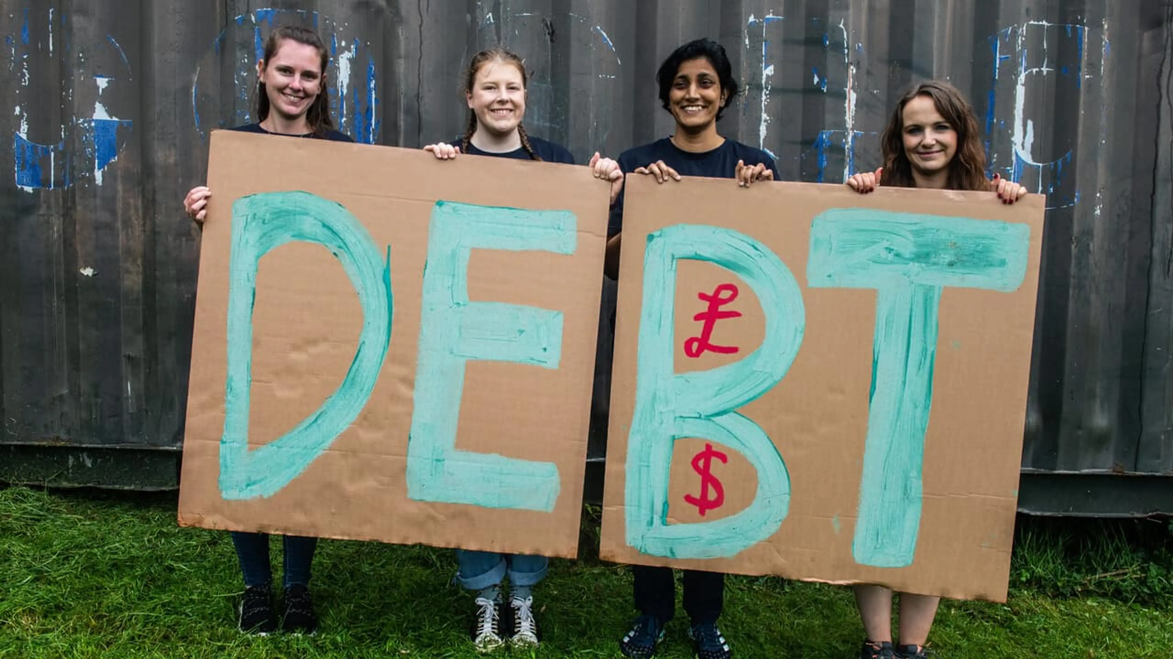UK - Plymouth - CAFOD supporters holding Debt sign at G7 2021