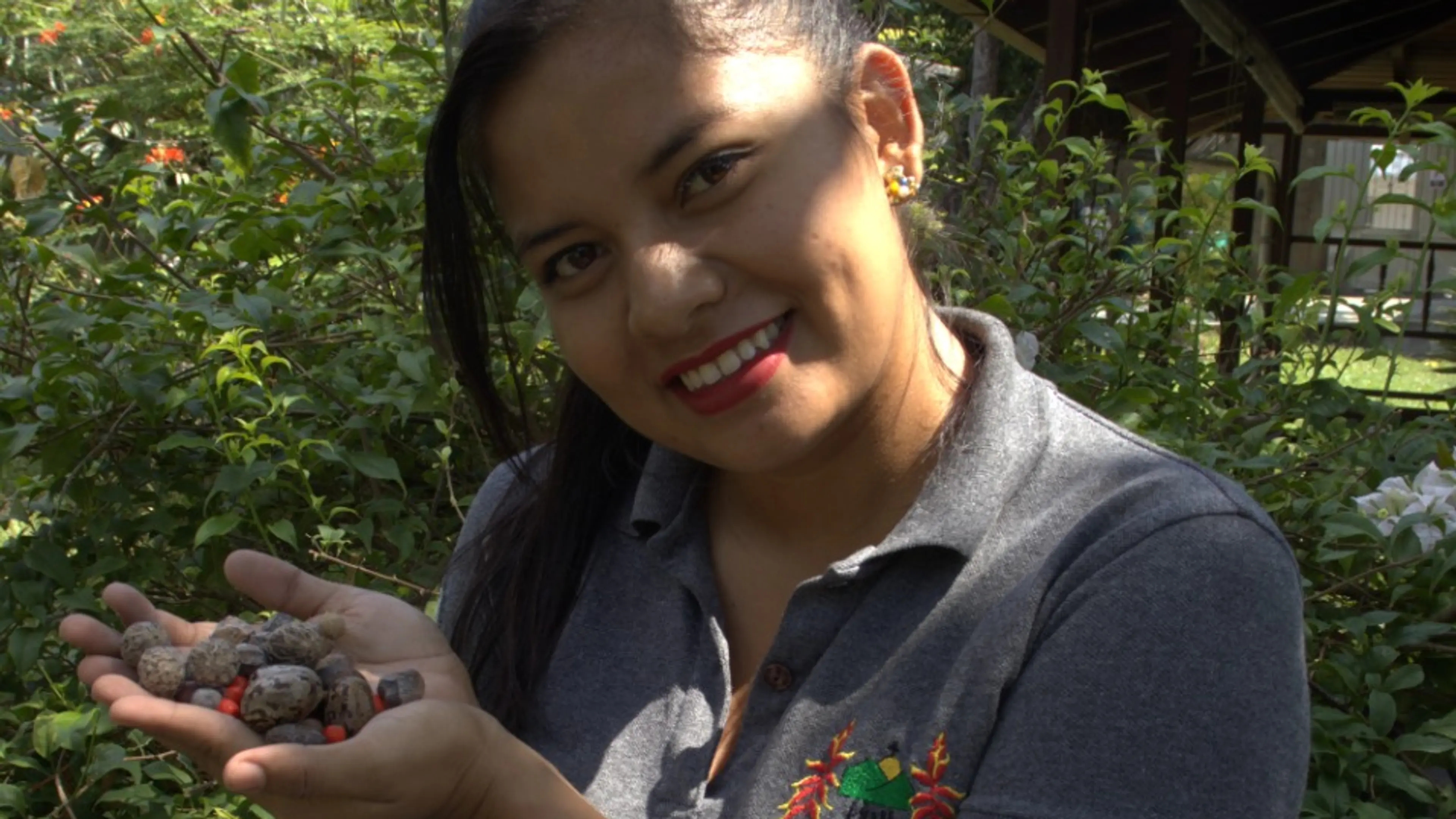 Jenny holding seeds from Amazon trees