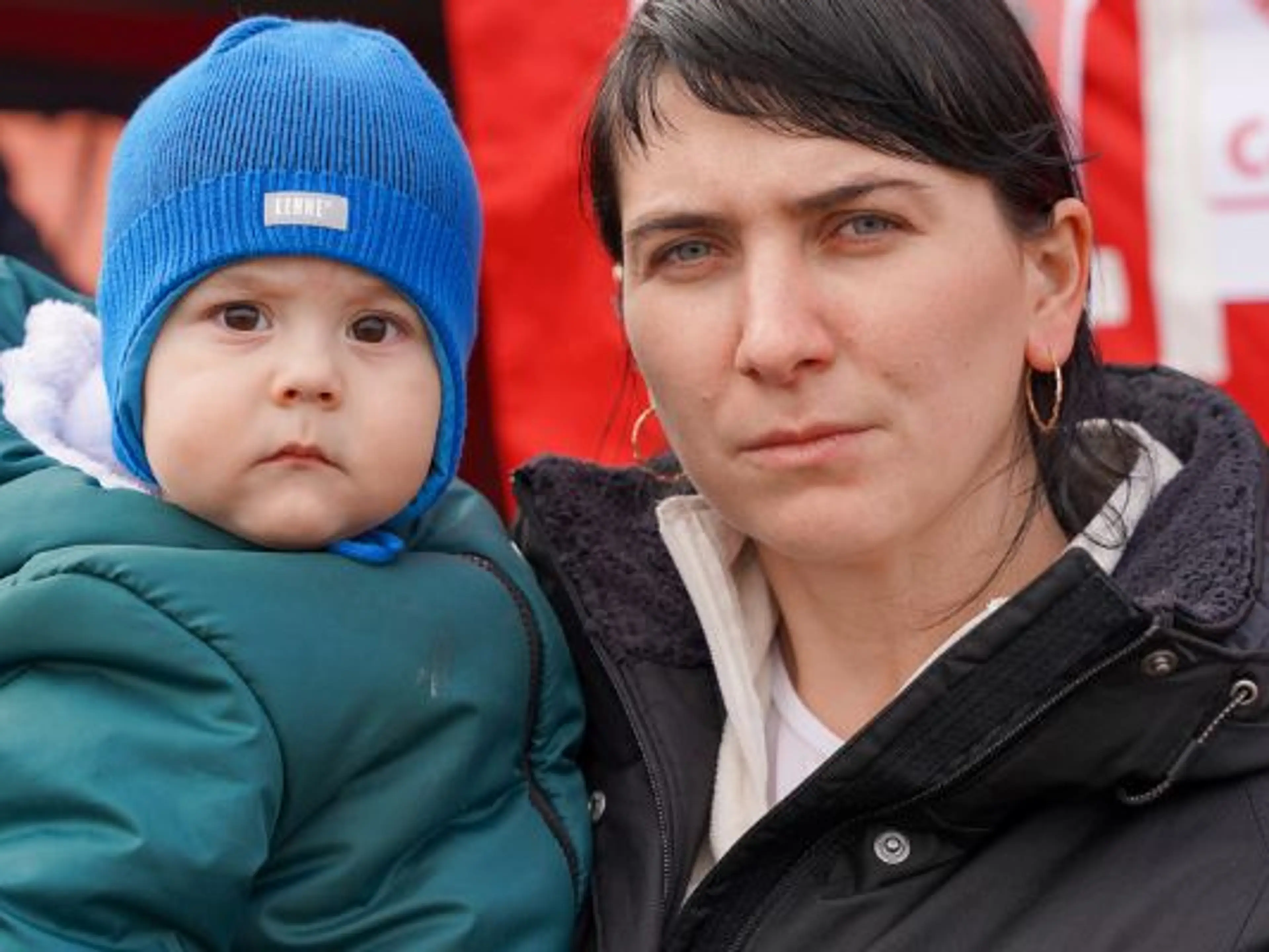 Ukraine refugees - a mother and her son cross into Poland.