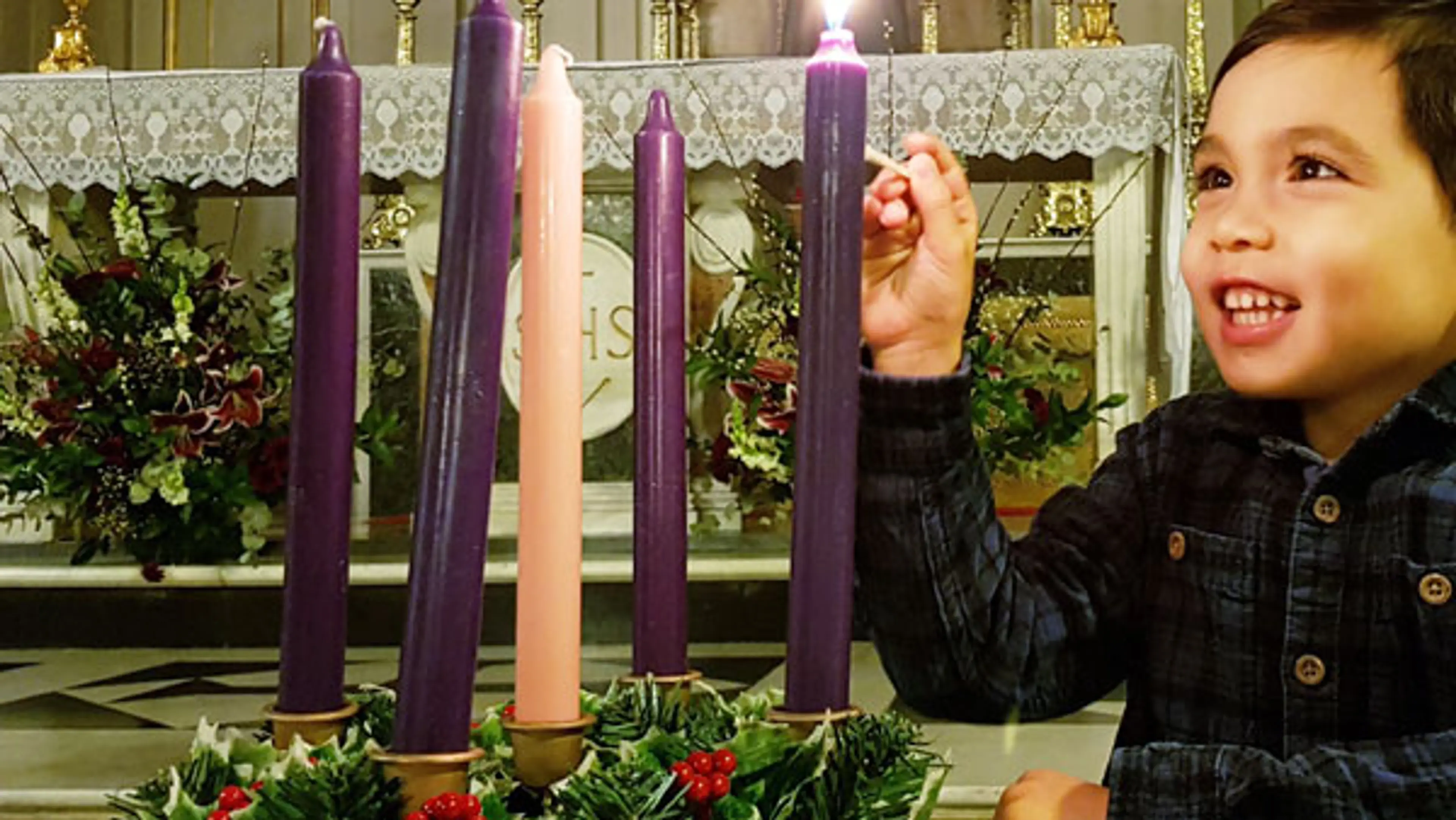 Boy lighting an advent candle