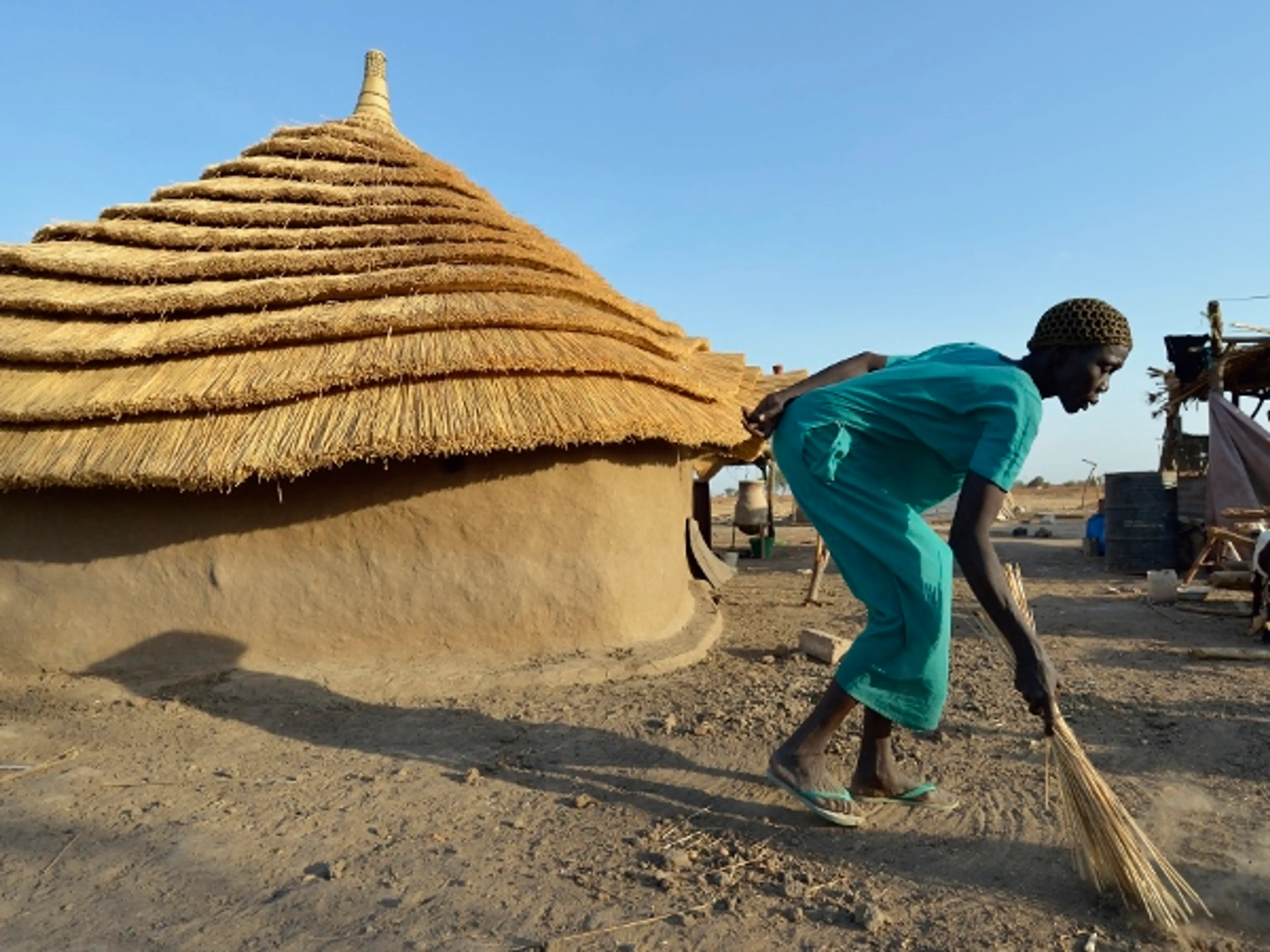 Africa - South Sudan - woman in front of Caritas home